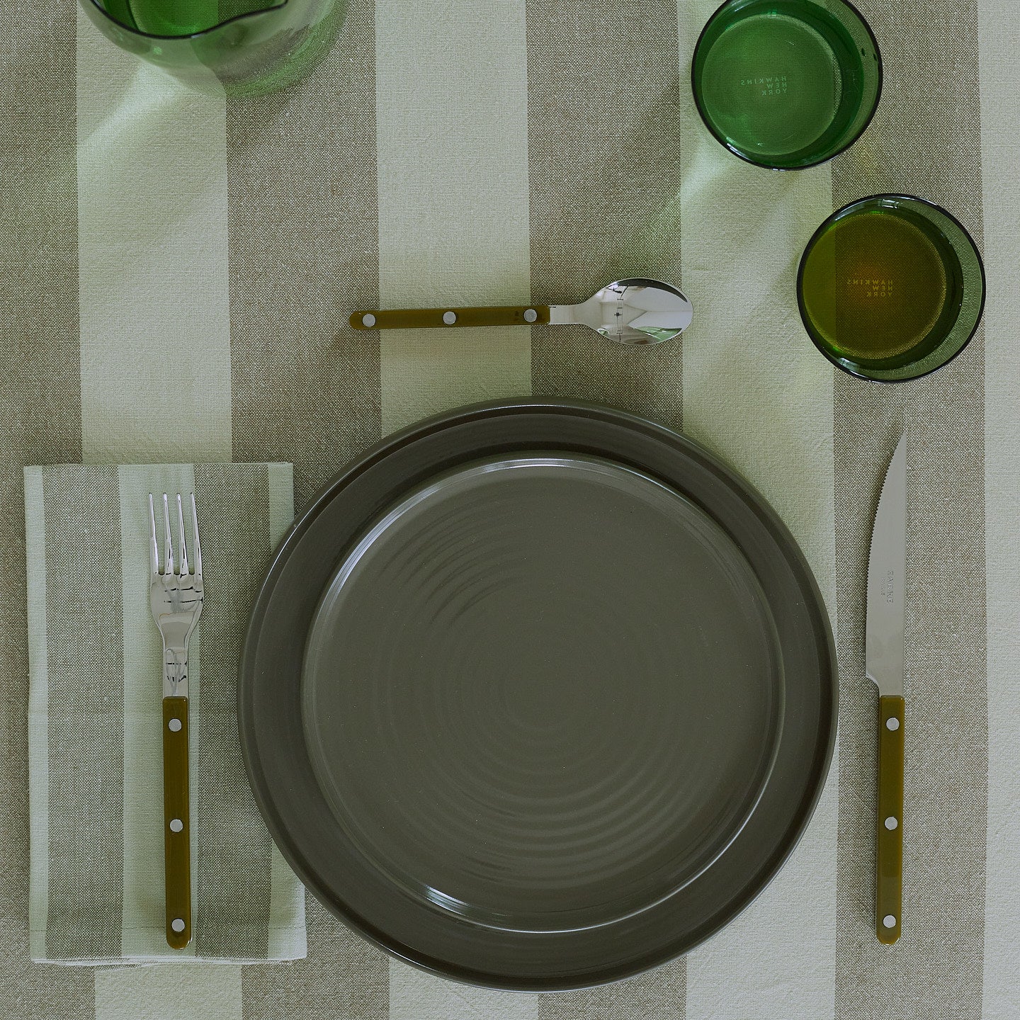 Placesetting on Essential Striped Tablecloth in Olive and Sage.