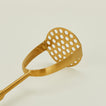 Close up view of brass potato masher