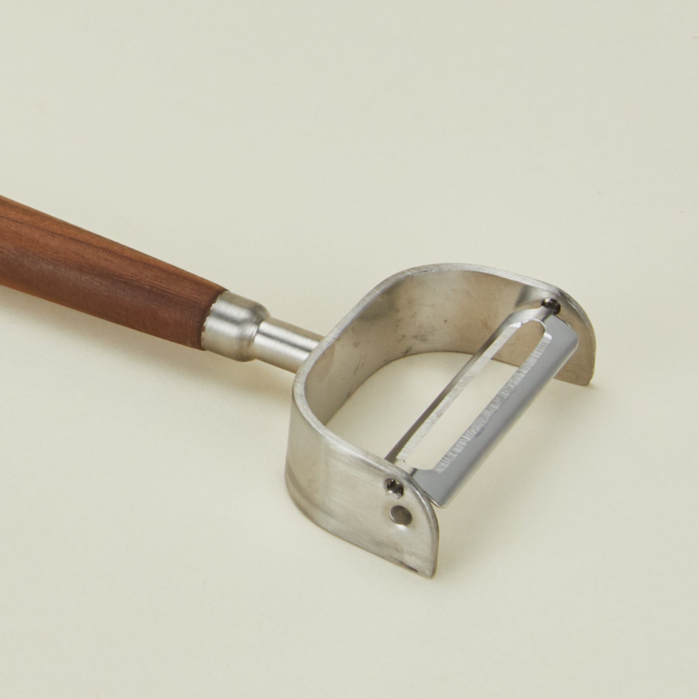 Cose up view of walnut handled vegetable peeler
