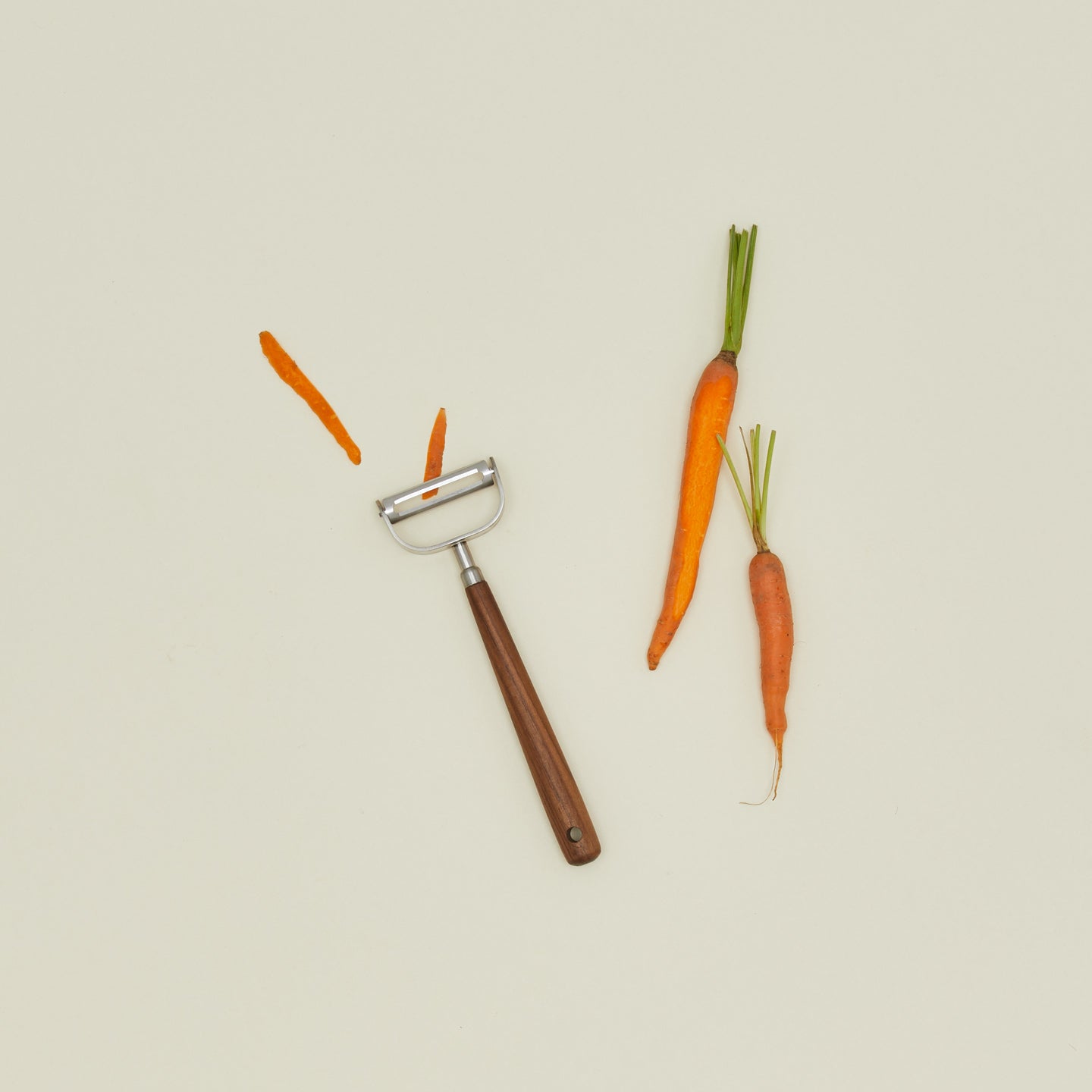Walnut handled vegetable peeler with carrots