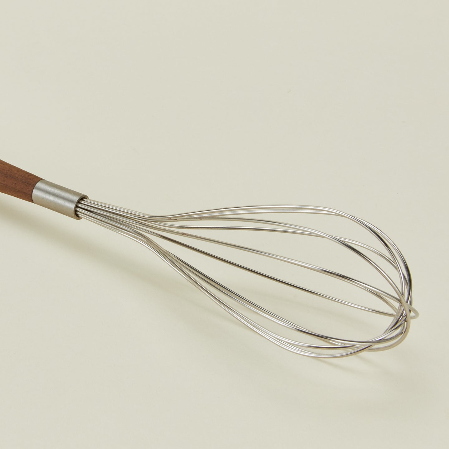 Close up view of Fodory walnut handled whisk