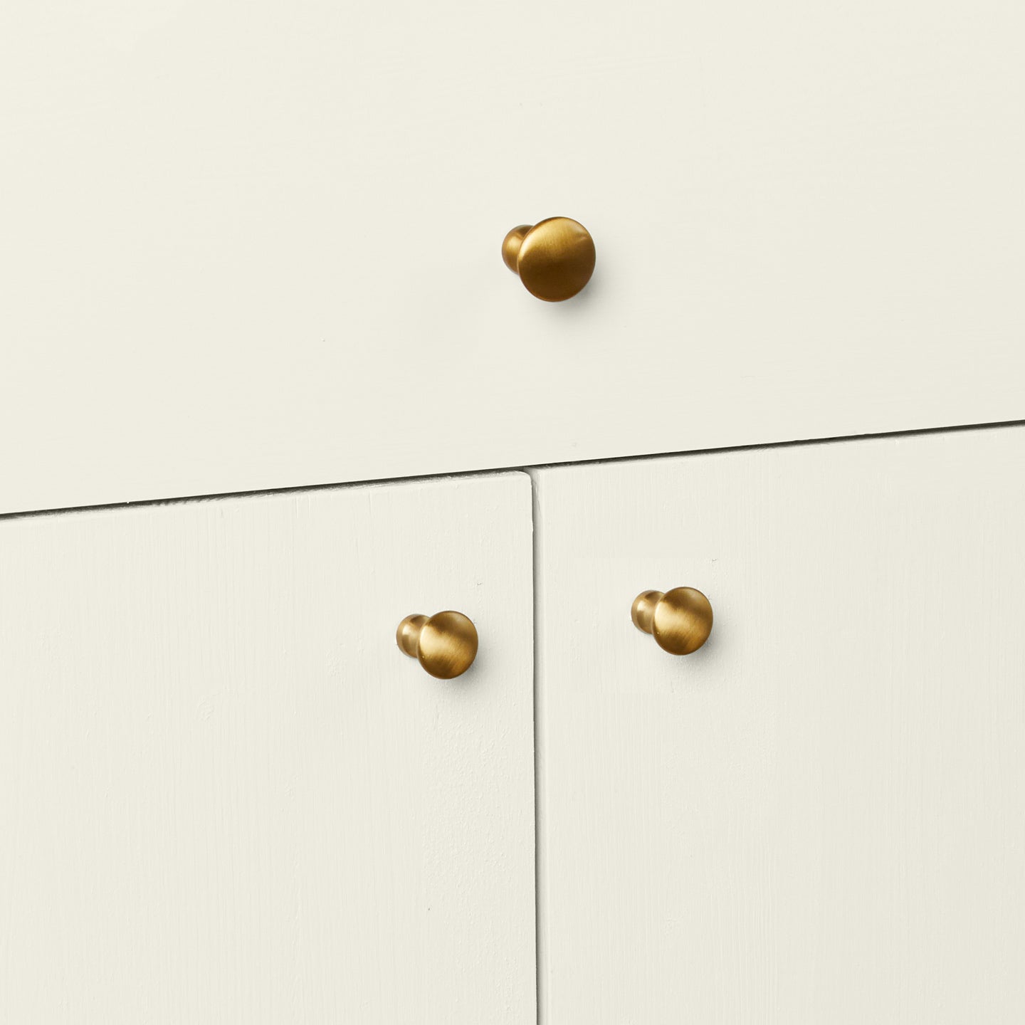 Brass knobs in large and small on cabinet doors