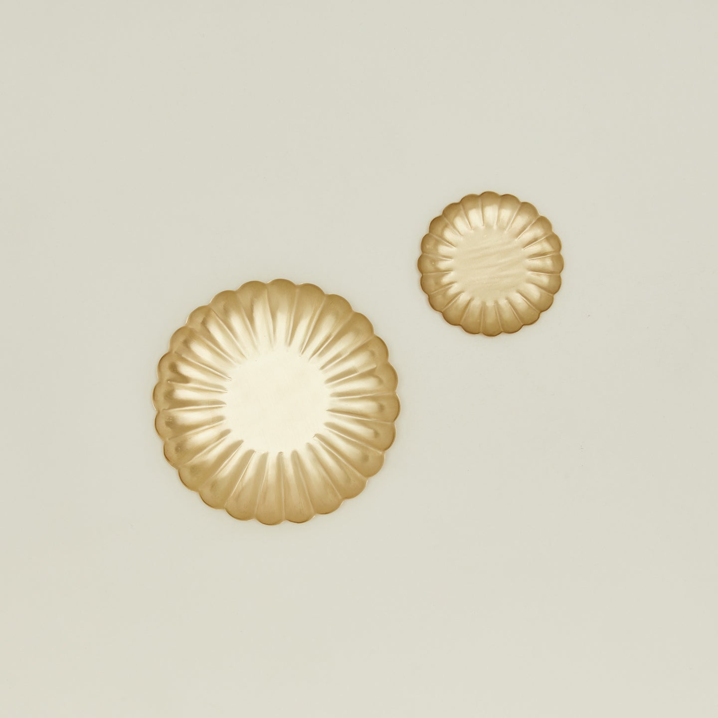 Overhead view of large and small brass petal plates