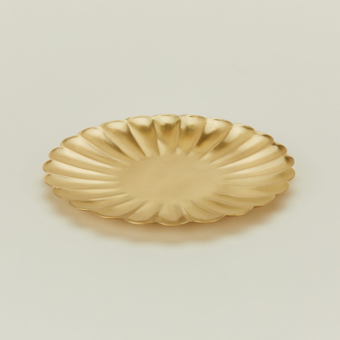 Close up view of large brass petal plate 