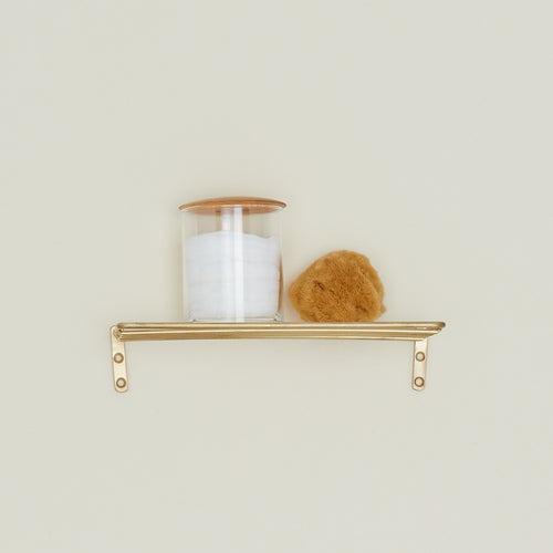 Fog Linen Brass shelf with storage container and sponge.