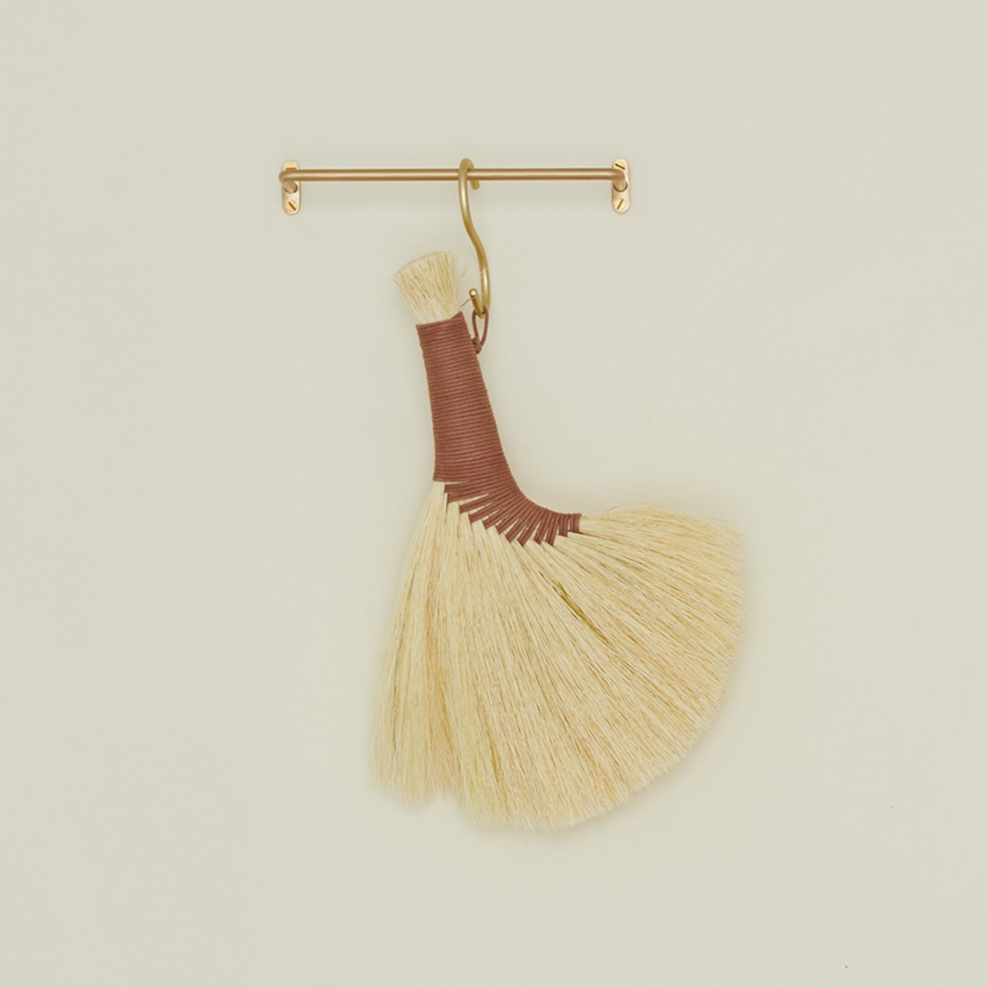 Small brass towel bar with turkey wing broom