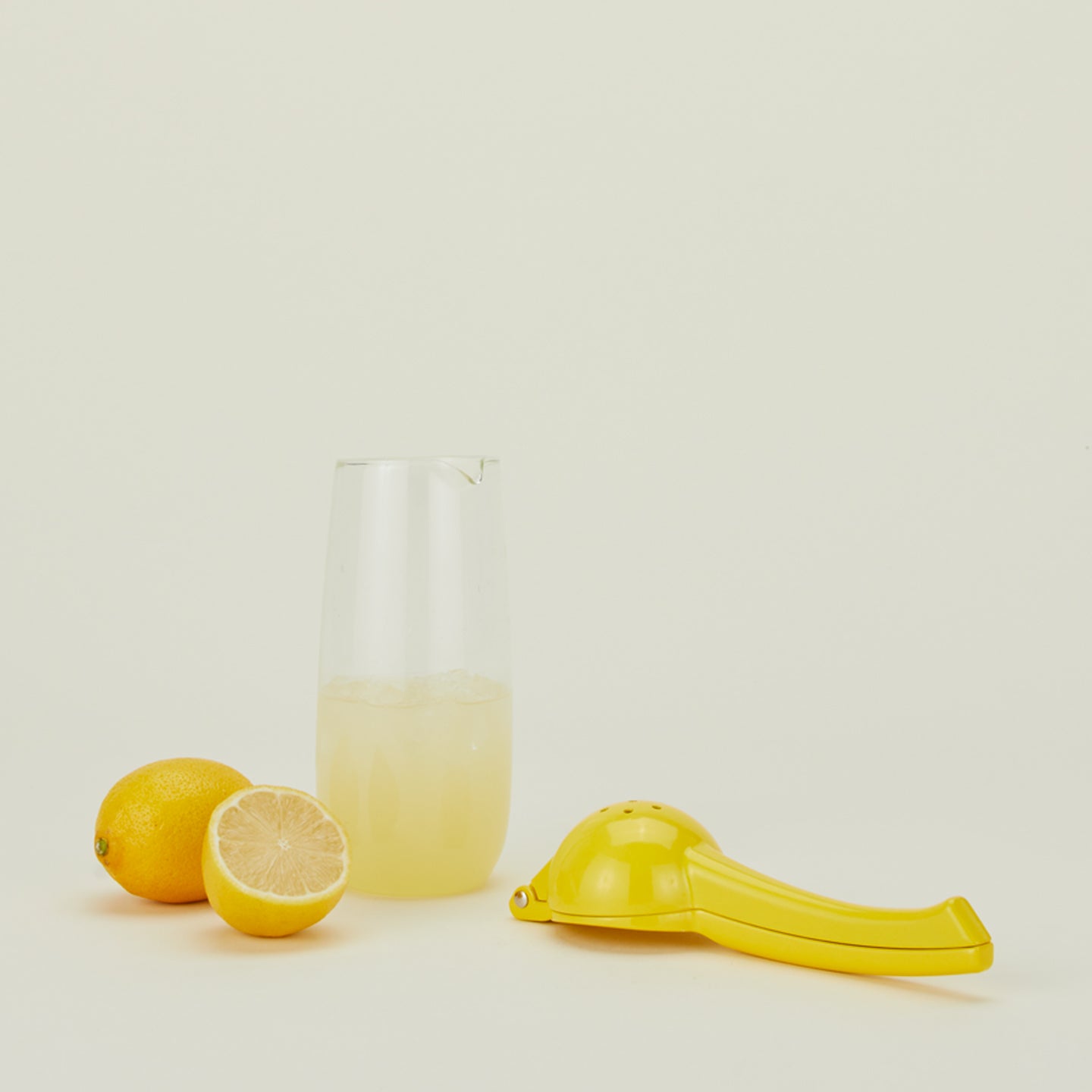 Fox Run lemon juicer with lemons and lemonade in a pitcher