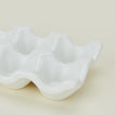 Detail view of ceramic half dozen egg holder in white