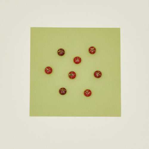 Red tomato candles on a green card on a beige background