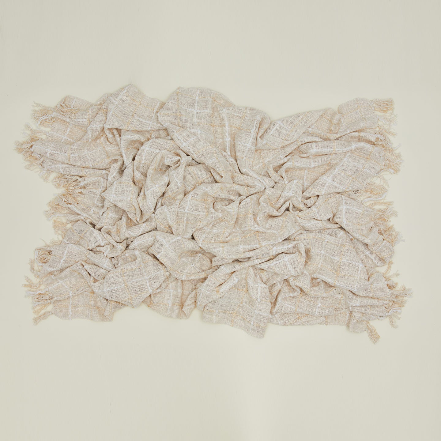 Overhead view of messy pacifica bed blanket