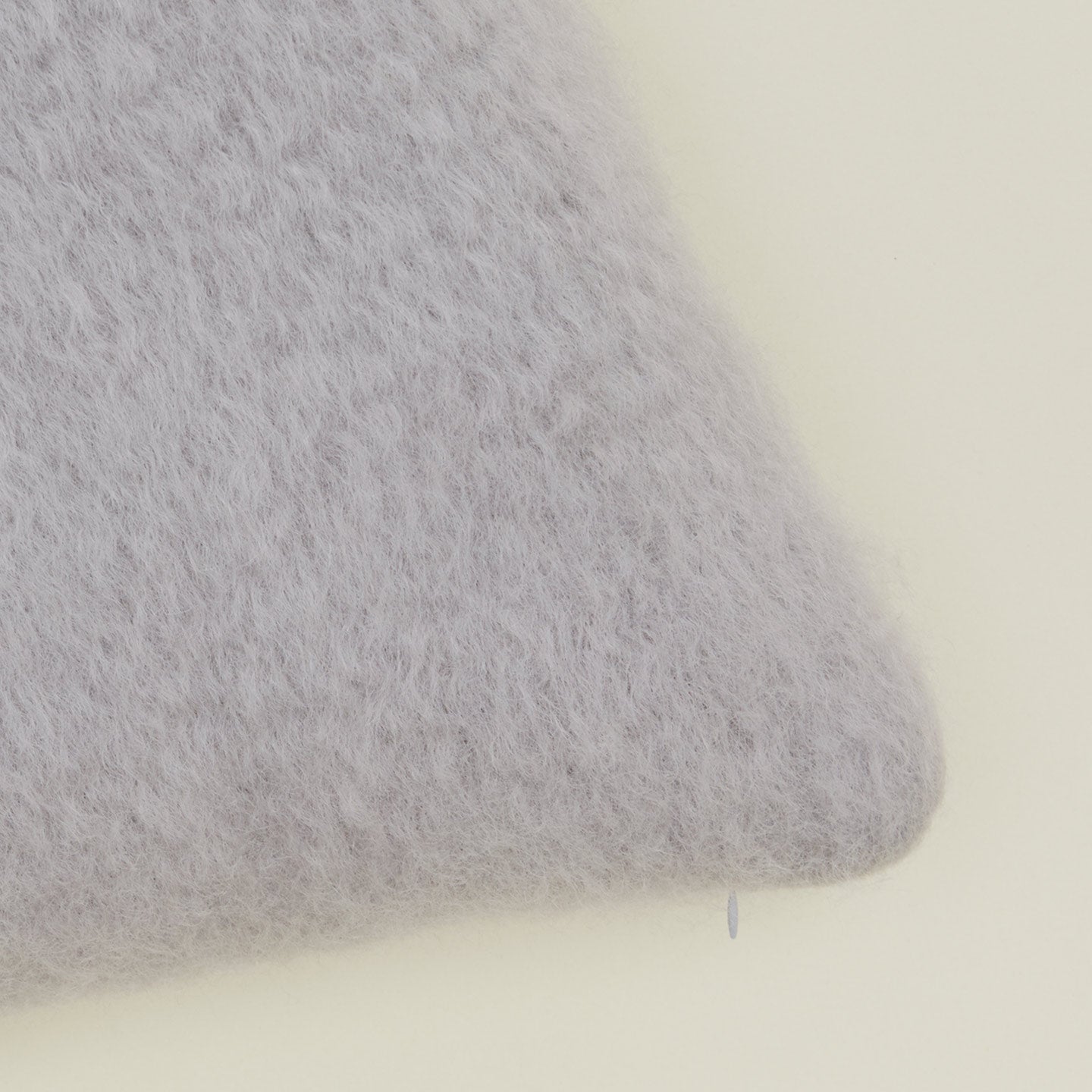 Close up view of light grey mohair pillow