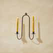 Double Iron Candle Sconce on a plaster wall with candles