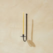 Single Iron Candle Sconce on plaster wall with candle