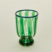 Close up view of green striped wine glass