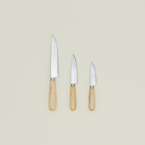 An overhead of three knives with wood handles in varying sizes.
