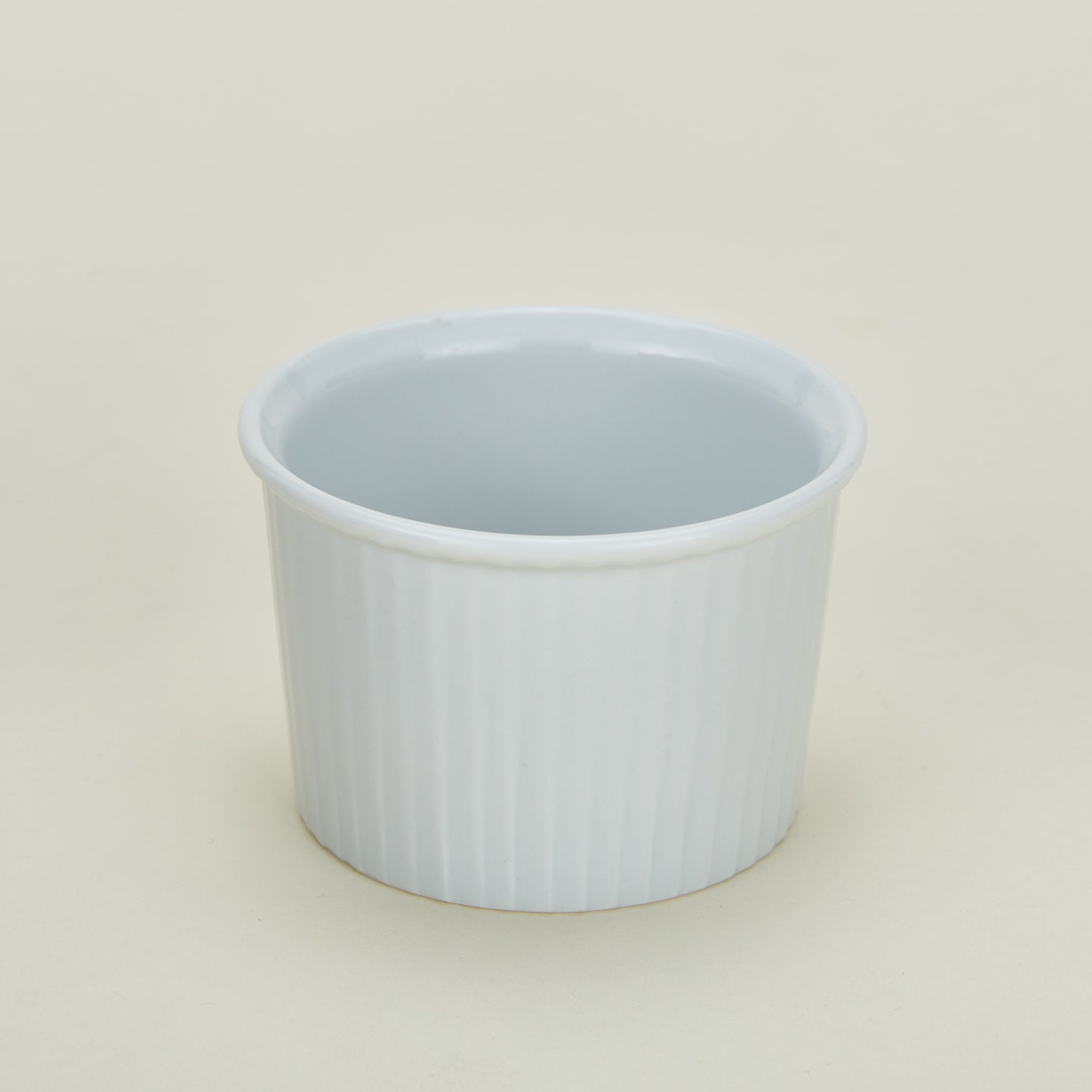 Detailed view of deep porcelain ramekin in white