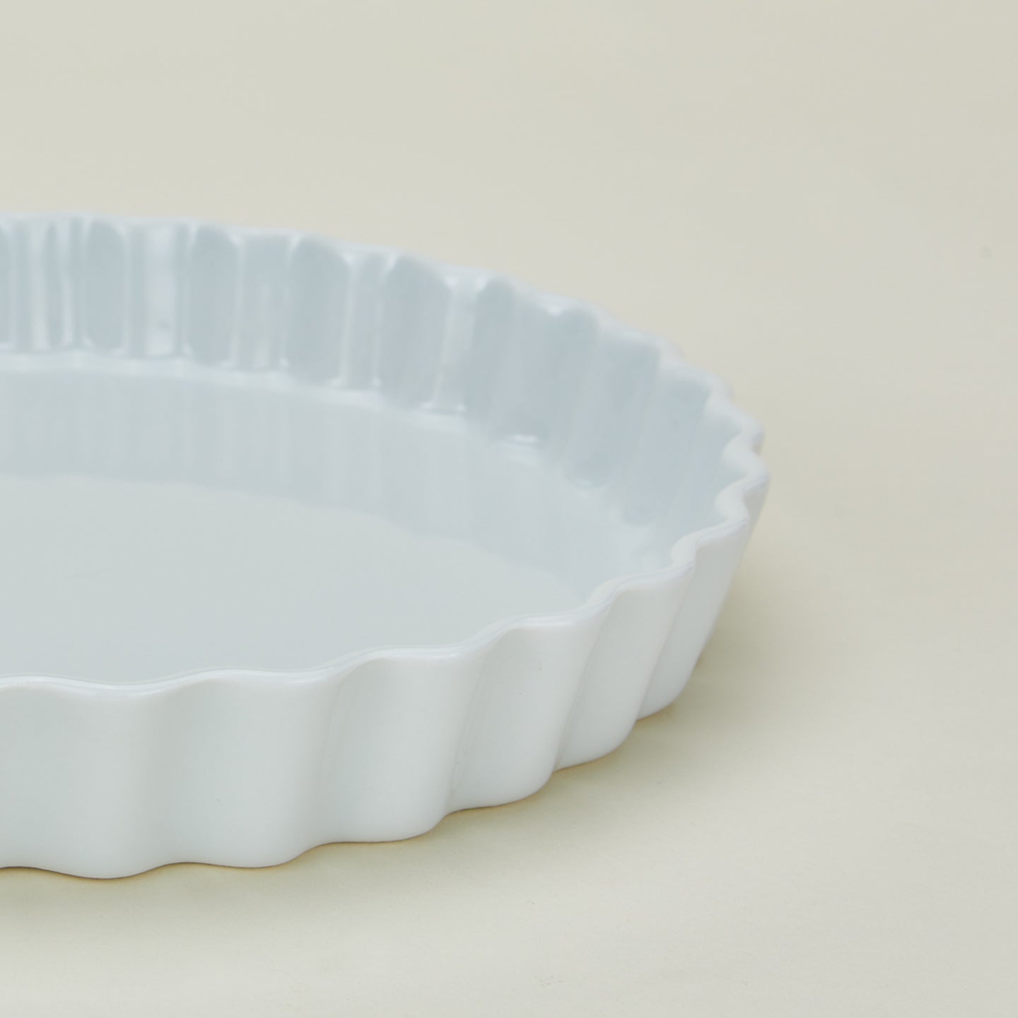 Detailed view of porcelain tart dish in white