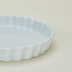 Detailed view of porcelain tart dish in white