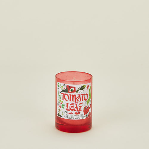 Candle with a 'Tomato Leaf' label on a beige background