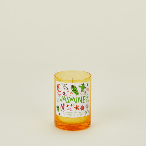 Candle with a colorful label on a beige background