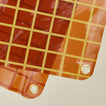 Close up view of sun grid shower curtain in honey