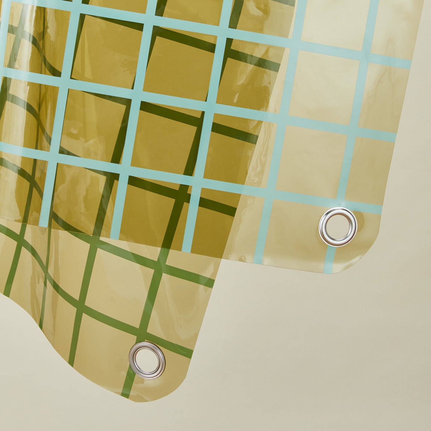 Close up view of sun grid shower curtain in olive