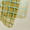 Close up view of sun grid shower curtain in olive