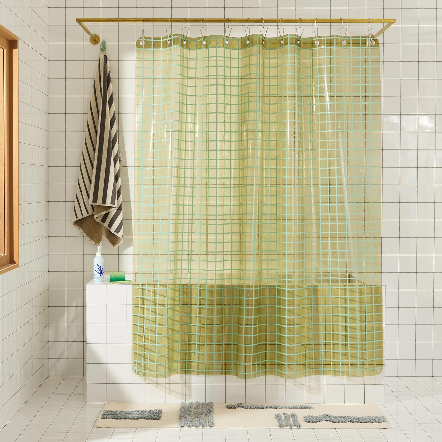 Sun grid shower curtain in olive in bathroom