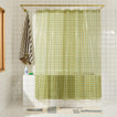 Sun grid shower curtain in olive in bathroom