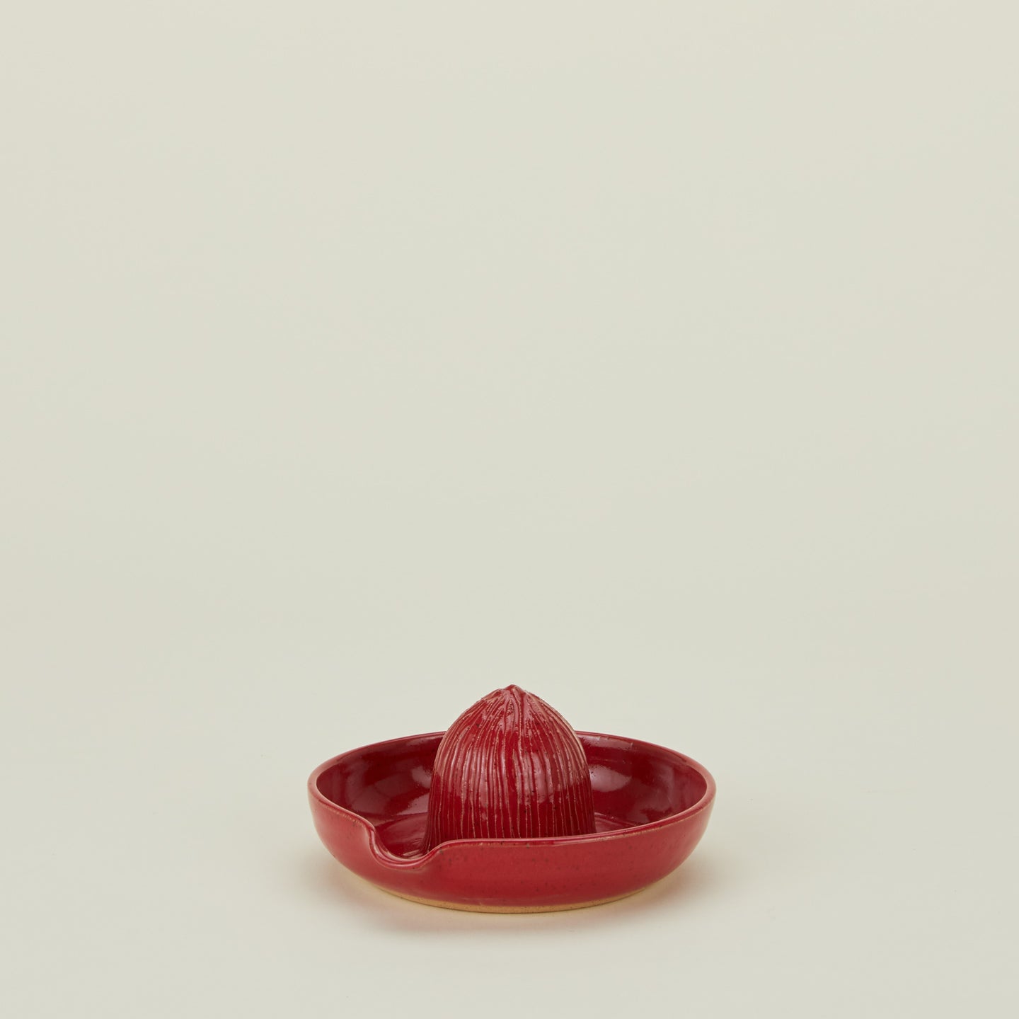 Stoneware citrus juicer in Coral.