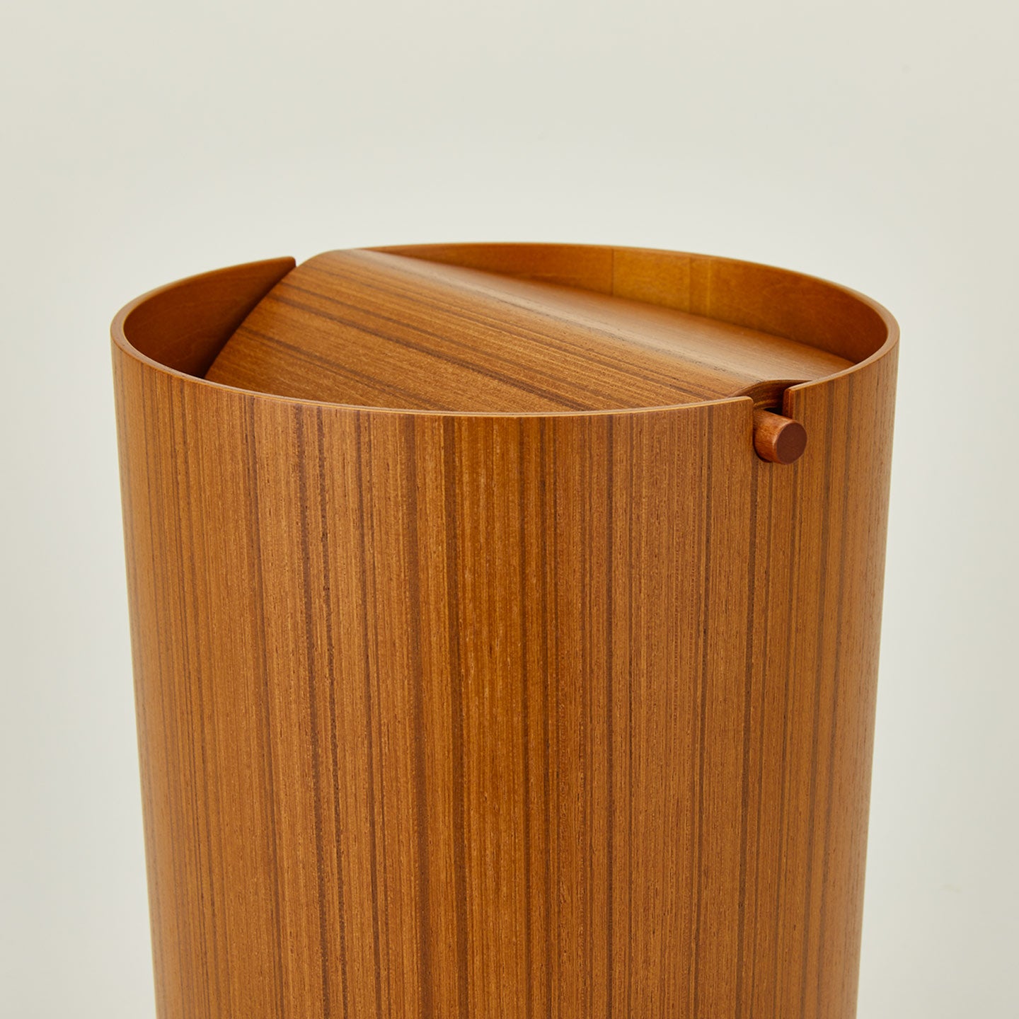 Close up view of lidded wooden waste basket in natural