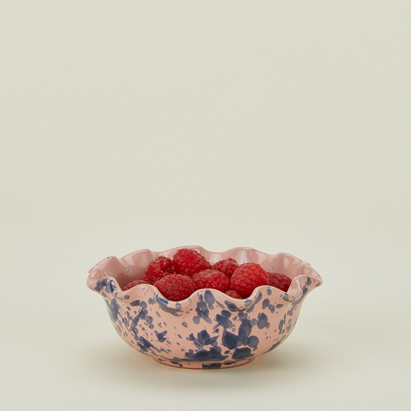 Splatter scallop bowl in pink and blue with raspberries