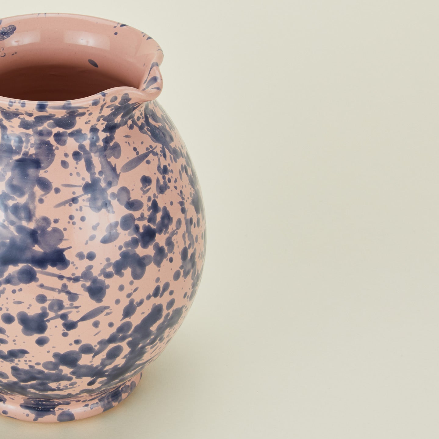 Close up view of Splatter cigno jug in pink and blue