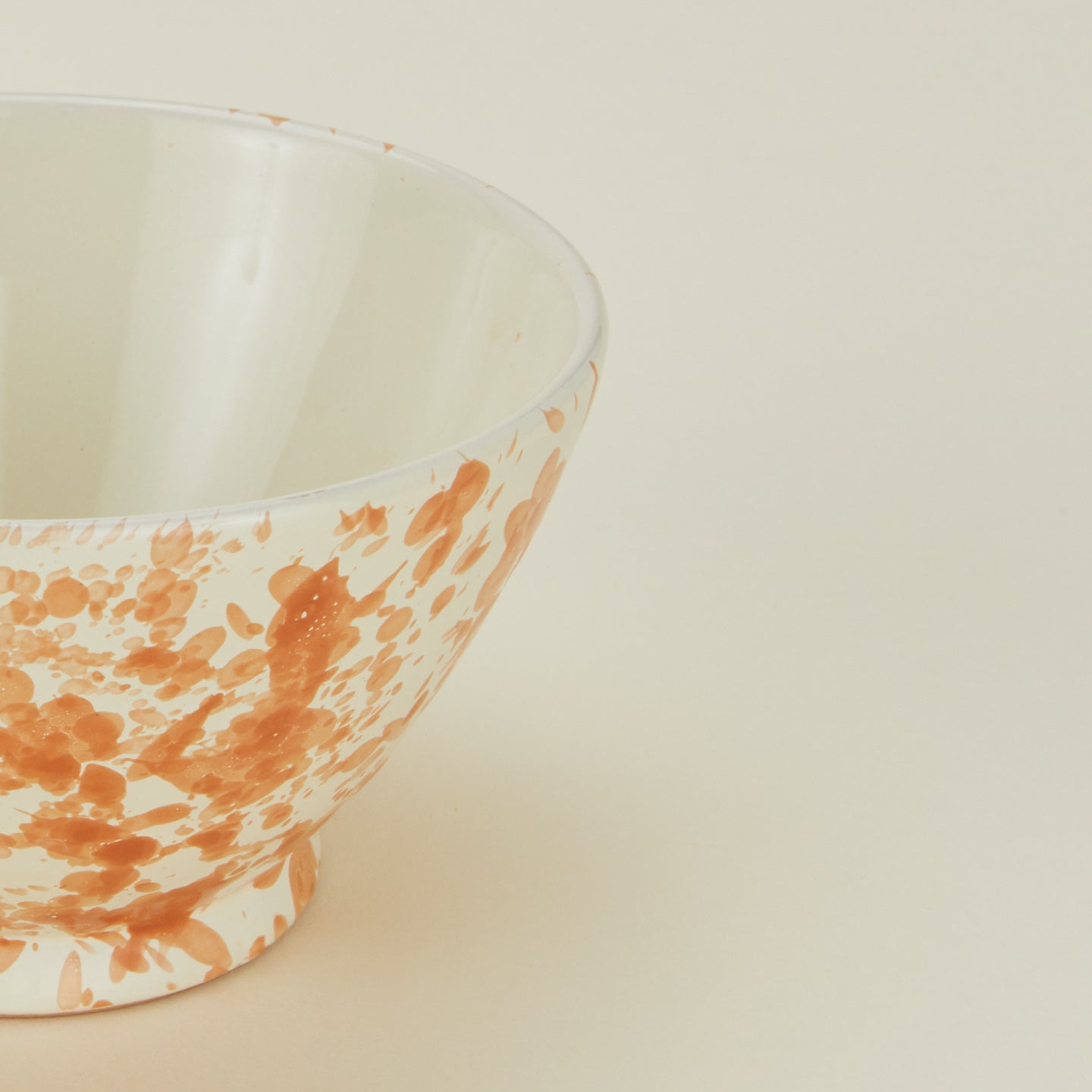 Close up view of Splatter small bowl in tan and ivory