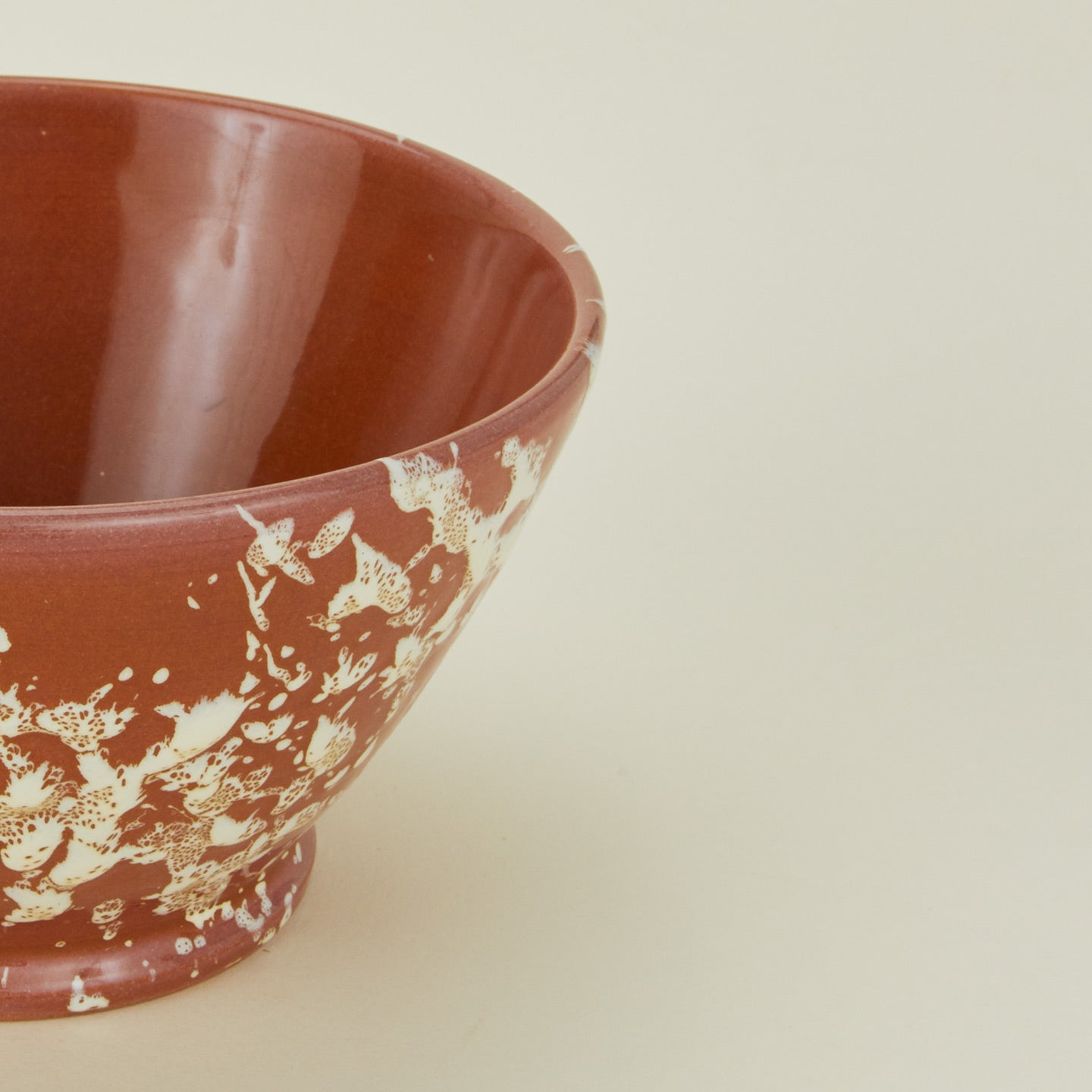 Close up view of terracotta ivory splatter small bowl