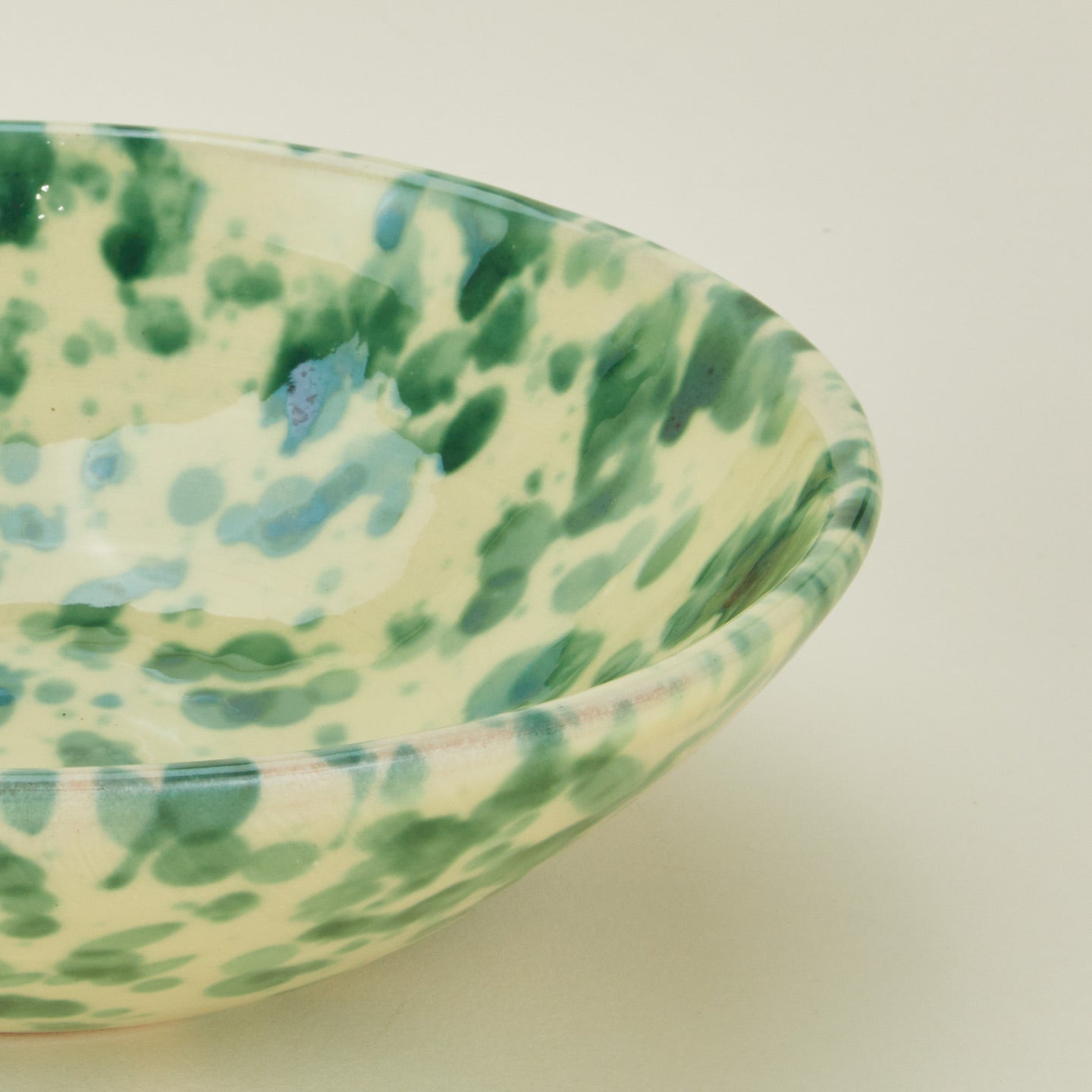 Close up view of Splatter low bowl in yellow and green