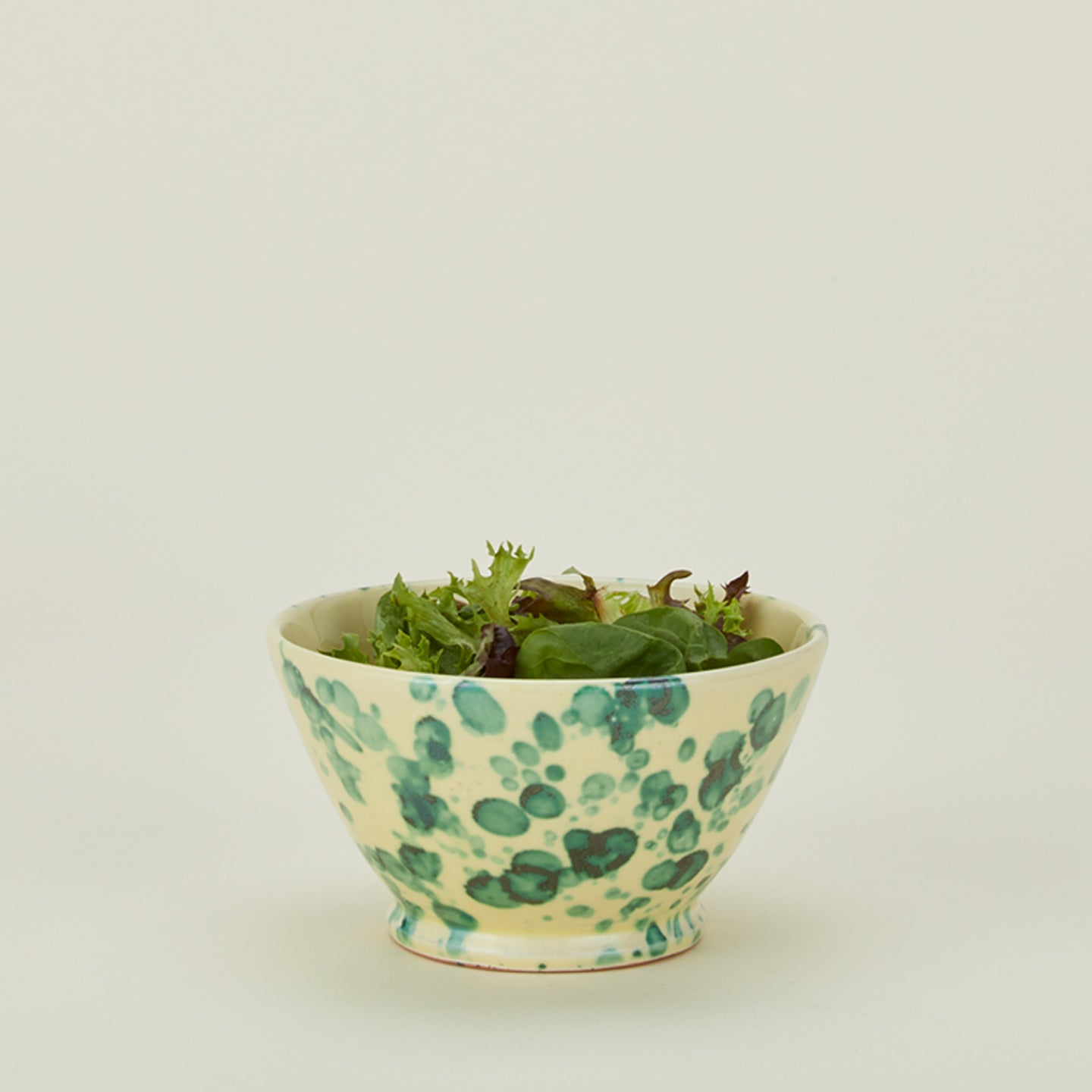 Splatter small bowl in yellow and green with salad 