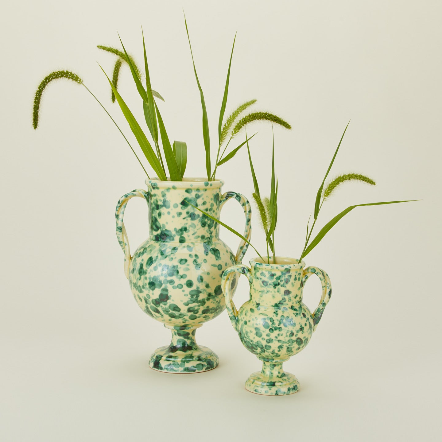 Yellow and green splatter verona vases in large and small with florals