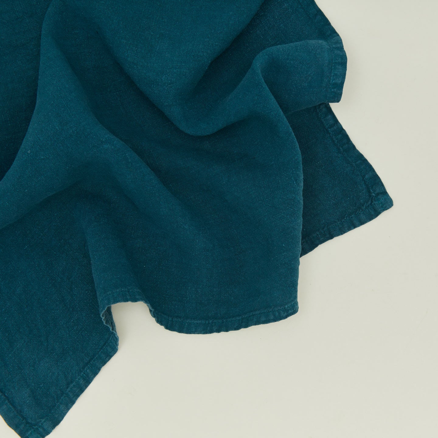 Detailed view of simple linen napkin peacock
