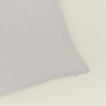 Close up view of simple linen pillow in light grey