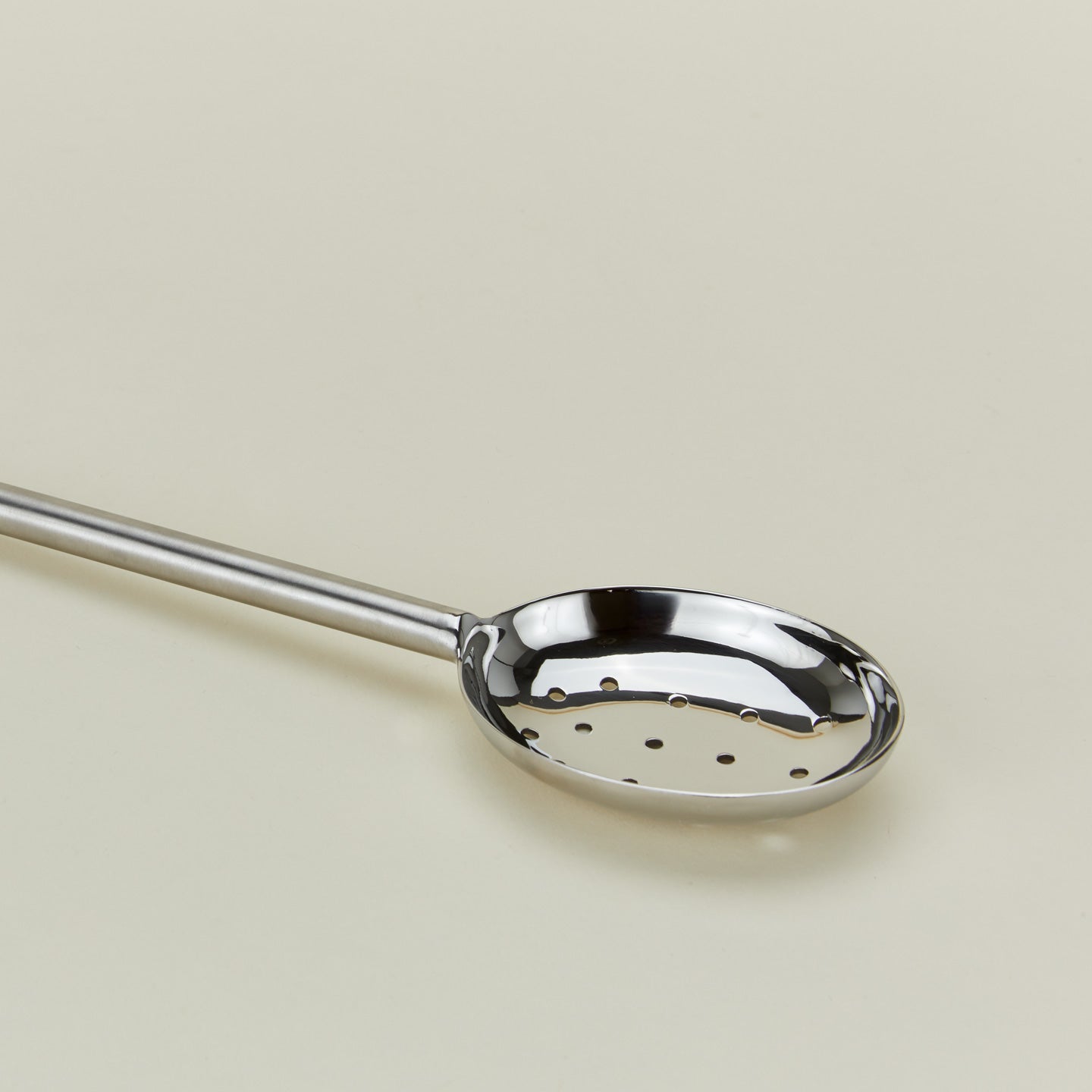 Close up view of Simple metal slotted spoon in silver