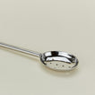 Close up view of Simple metal slotted spoon in silver