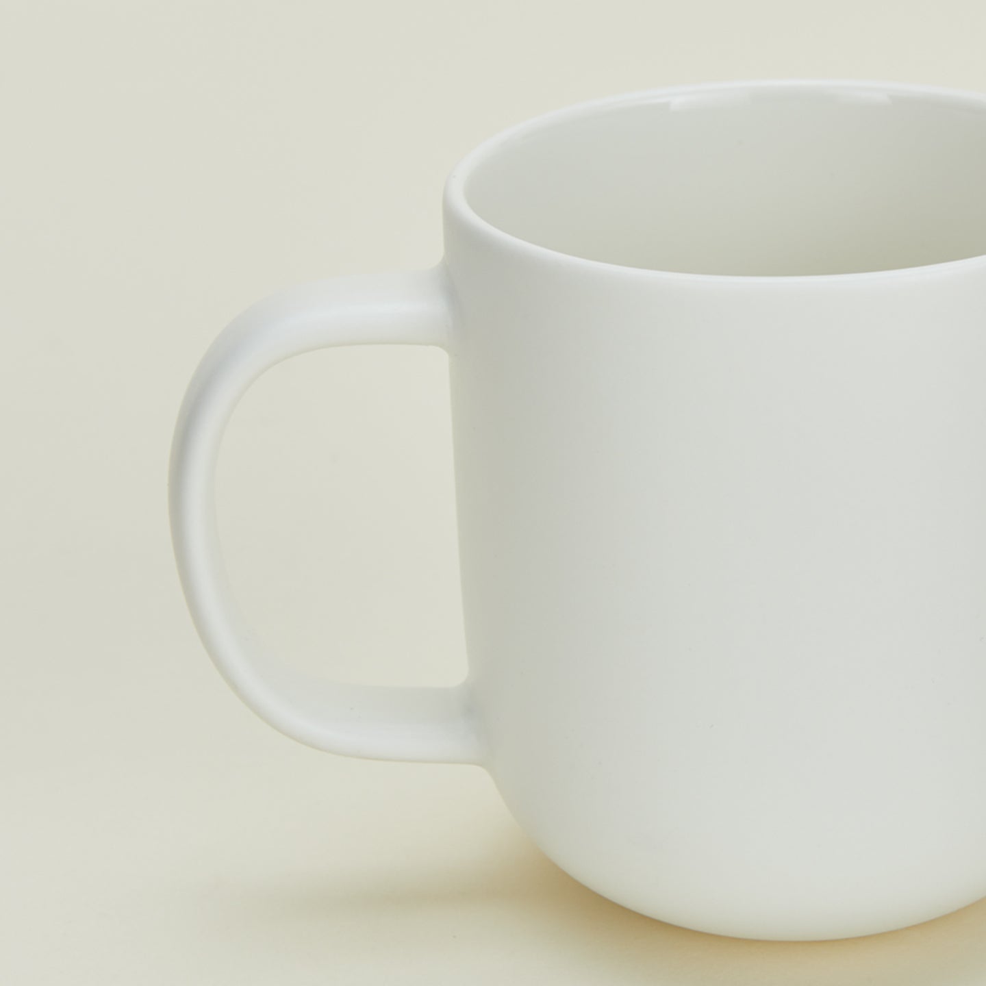 Close up view of simple porcelain dinnerware mug in white