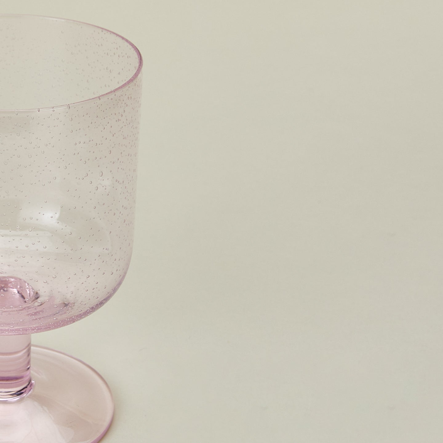 Detailed view of simple seeded glassware in blush