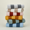 Stack of simple striped throws in various colors