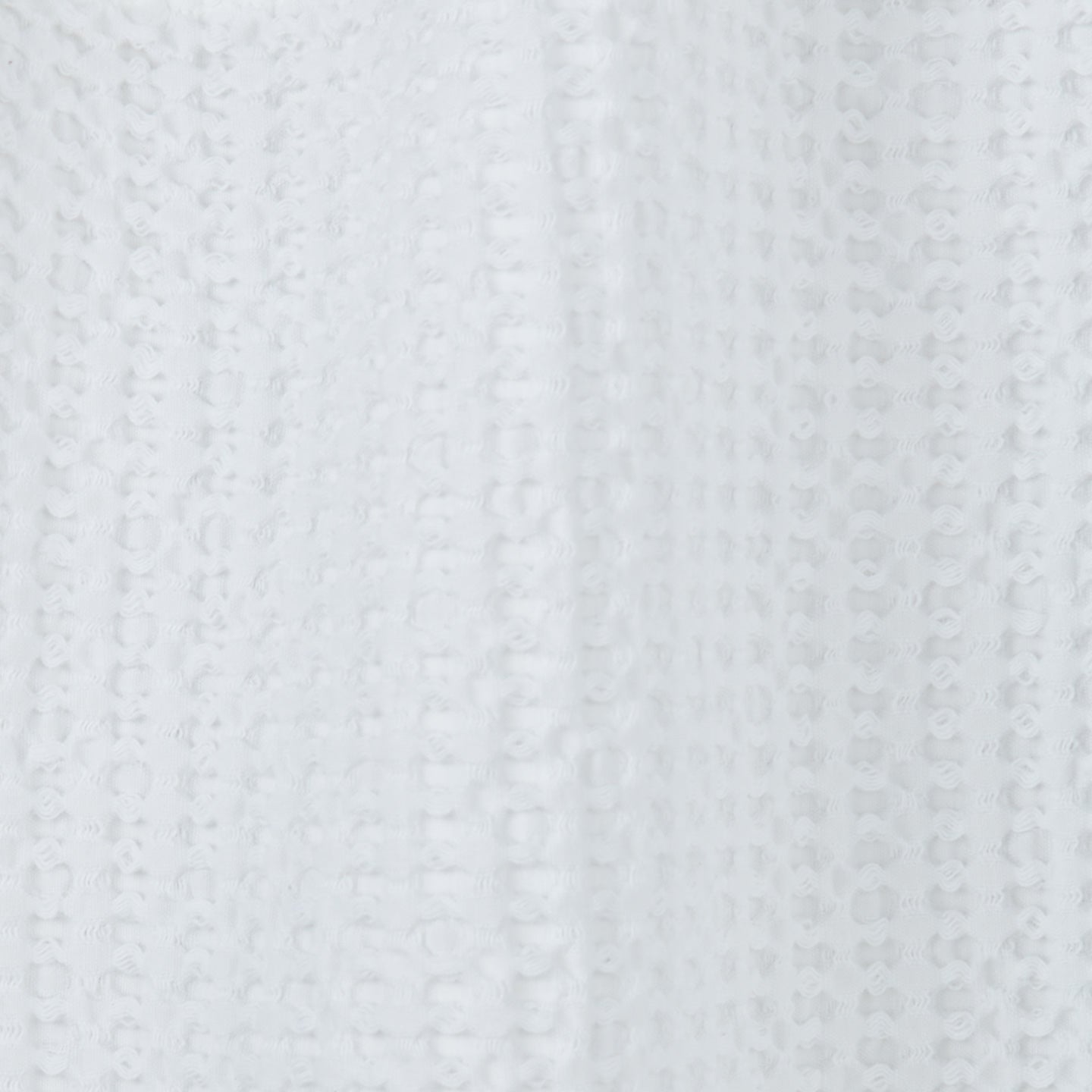 Close up view of simple waffle shower curtain in white