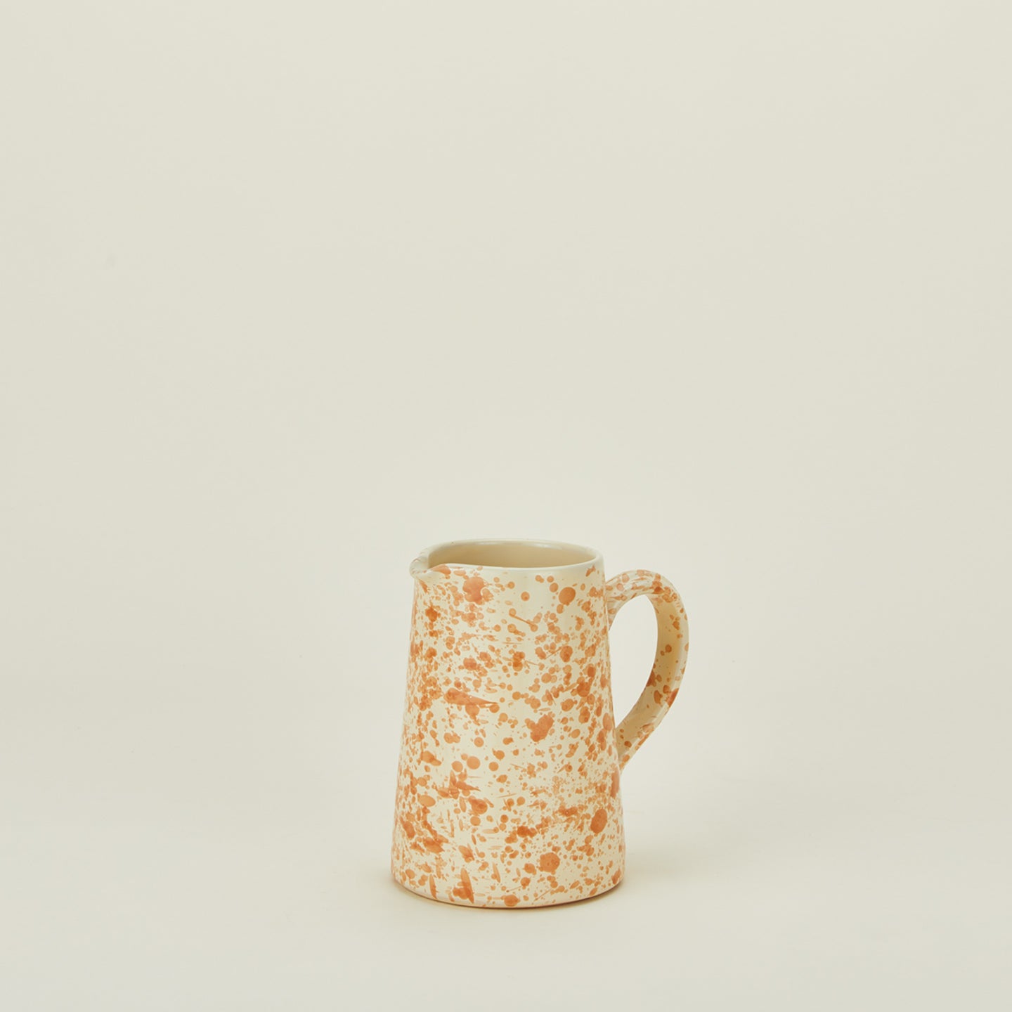 Small splatterware pitcher in ivory and bronze