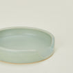 A close up of a seafoam stoneware spoon rest.