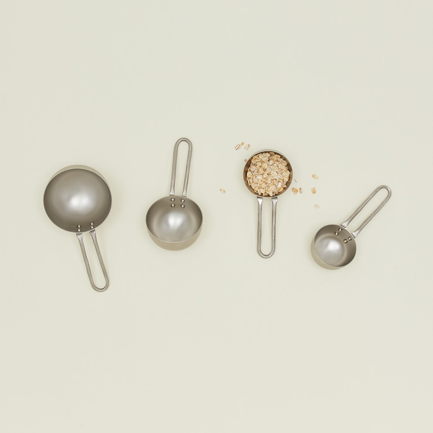 The collective foreged pewter measuring cups, set of 4 with oatmeal