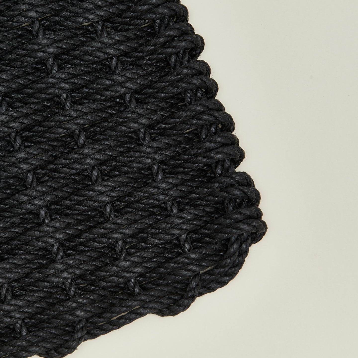Closeup view of woven doormat in charcoal